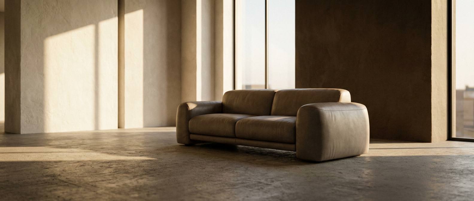 Taupe leather sofa in a sunlit gallery